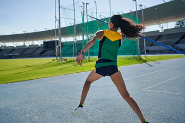 Female track and field athlete throwing javelin