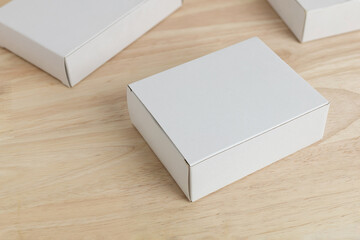 white paper box on wooden table for mockup blank template