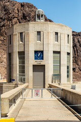 Fototapeta na wymiar A clock on a Hoover Dam intake indicates the time on the Nevada side of the Colorado River 
