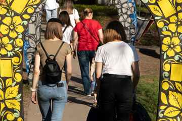 People walk in the park through the arch