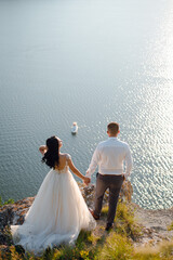 Sensual wedding couple groom and bride near the beautiful lake
