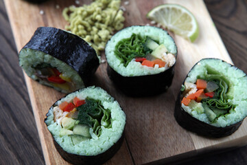 hot roll set sashimi japanese food on wooden background with lemon and chopsticks