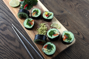 hot roll set sashimi japanese food on wooden background with lemon and chopsticks