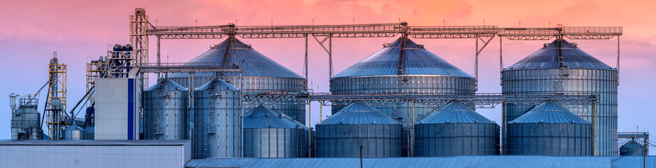 Large agricultural grain processing plant at sunset