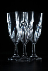 three empty wine glasses on black background
