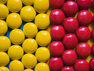 Top view of yellow and red chocolate candies.  Colorful background