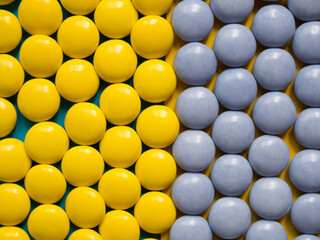 Top view of yellow and blue chocolate candies. Colorful background concept