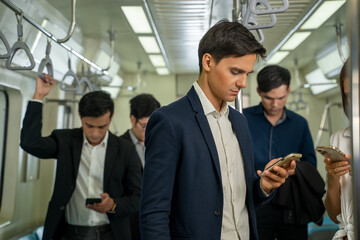 Business people and office worker with smartphone in subway while traveling to work passengers traveling concept.