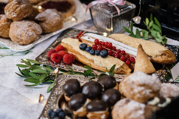 cakes on the table, garnished with fresh raspberries and red currants