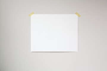 Horizontal poster mockup taped to a neutral coloured wall. 4:5 aspect ratio poster.