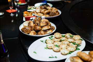 baked pies on a plate as a party snack and salad in tartlets
