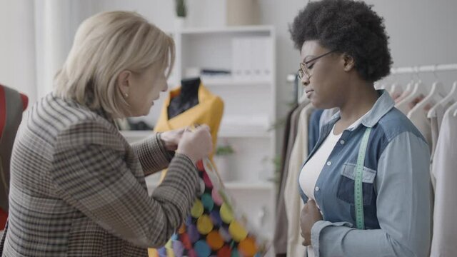 Angry female shouting at tailor in fashion studio, problems of customer service