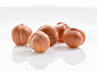 Whole kernels of hazelnut on white background
