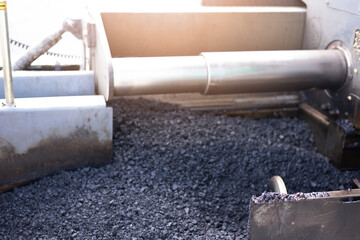 Details of industrial machinery working with asphalt, mixing bitumen with hot asphalt, layering on the road surface
