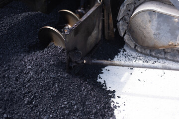 Modern heavy asphalt roller that stack and press hot asphalt. Yellow road repair machine. Repairing in modern city with vibration roller compactor