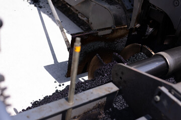 Modern heavy asphalt roller that stack and press hot asphalt. Yellow road repair machine. Repairing in modern city with vibration roller compactor