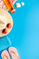 Layout of beach accessories with sraw hat, sunglasses and flip flops