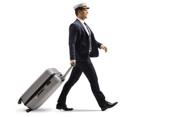 Full length profile shot of a young pilot walking with a suitcase