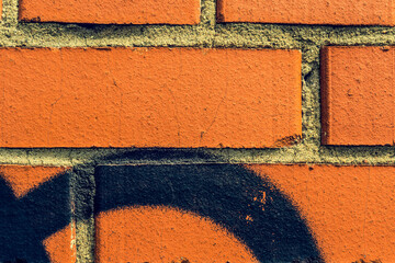 Graffiti on a red brick wall. Close-up view - obrazy, fototapety, plakaty