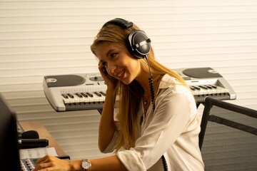 Caucasian young musical performance singer recording in creative studio with producer 