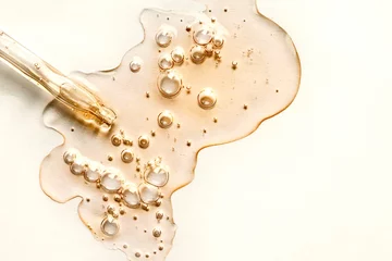 Fotobehang Yellow texture of a drop of whey or olive oil on a white background. Transparent sample of cosmetic gel with bubbles. Golden acid cream. Vitamin c. A drop of honey. Hyaluronic acid. © Valentina Shilkina