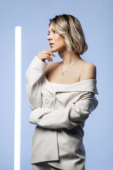 singer posing in the studio. Around the girl neon lamps