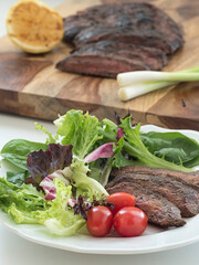 Steak Salad Plate with Steak in Background
