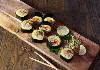 Sushi Set - Different Types of Maki Sushi and Nigiri Sushi. Served on dark wooden table.