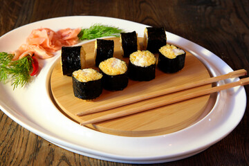 Sushi Set - Different Types of Maki Sushi and Nigiri Sushi. Served on dark wooden table.