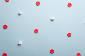 medical flatlay red and white blood cells. Red blood cells and leukocytes on a blue background.