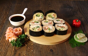 Sushi Set - Different Types of Maki Sushi and Nigiri Sushi. Served on dark wooden table.