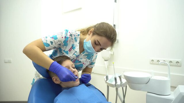 4K A child with a dentist in a dental office.