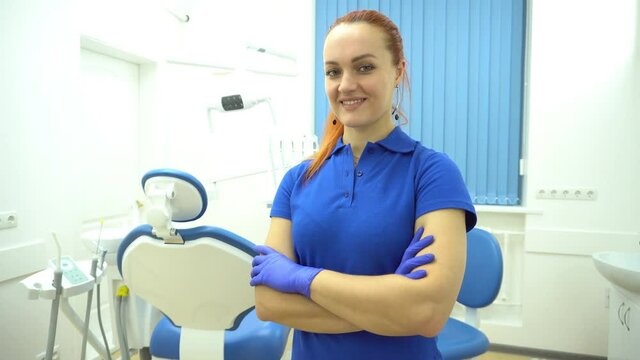 4K Portrait of female dentist .She standing in her dentist office.