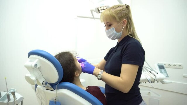 4K Woman having teeth examined at dentists. Dental treatment in dentistry. Appoi