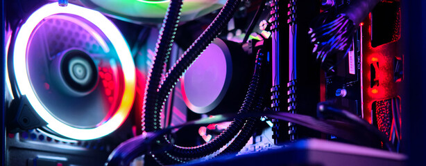 Top-end system unit for gaming computer close up. Inside of illuminated cybercafe. Concept of...
