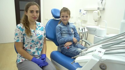 Slow Motion Smiling little girl gives five to the dentist, dentist chair