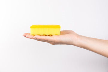 Sponge for washing dishes in female hand. Woman's hand gesture or sign isolated on white. A hand holds a sponge for washing and cleaning dishes