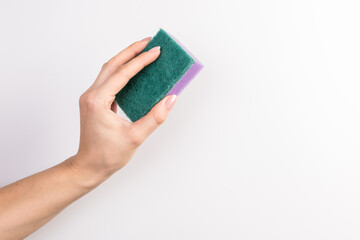 Sponge for washing dishes in female hand. Woman's hand gesture or sign isolated on white. A hand holds a sponge for washing and cleaning dishes