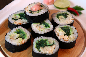 Sushi Set - Different Types of Maki Sushi and Nigiri Sushi. Served on dark wooden table.