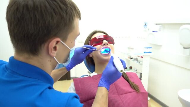 Using a modern method of laser teeth treatment. Dental care, perfect smile