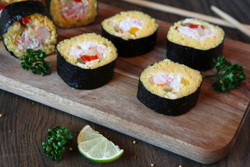 Sushi Set - Different Types of Maki Sushi and Nigiri Sushi. Served on dark wooden table.