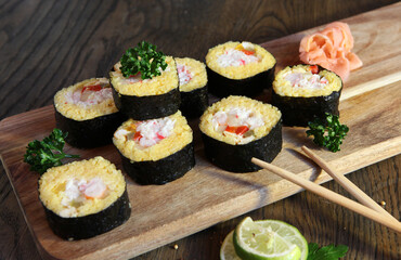 Sushi Set - Different Types of Maki Sushi and Nigiri Sushi. Served on dark wooden table.