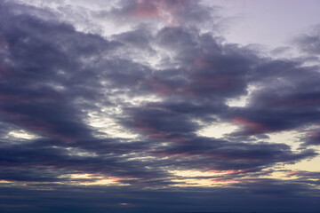 Dark red clouds in the evening at sunset.