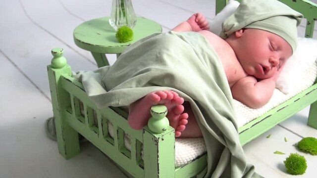 Slow Motion newborn baby in white colors. first photo session of a newborn