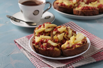 Baked homemade sandwiches with sausage, cheese and pineapple. Delicious breakfast or snack.