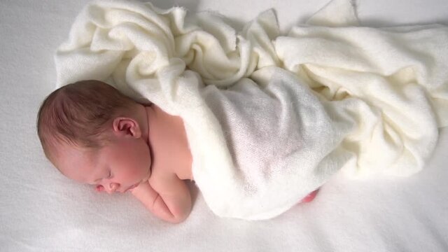 Adorable newborn baby girl is sleeping on white background. Beginning of life an