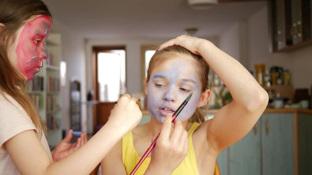 Face painting funny children girls at home making body art to each other