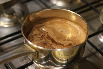 Cocoa is cooked in a saucepan on the stove