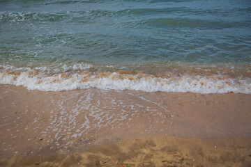 Clean and relaxing sea wave splashes over seashore. Idyllic seascape for beach wedding or honeymoon. Exotic seaside banner . Caspian Sea sea water over white sand beach.