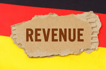 Against the background of the German flag lies cardboard with the inscription - revenue